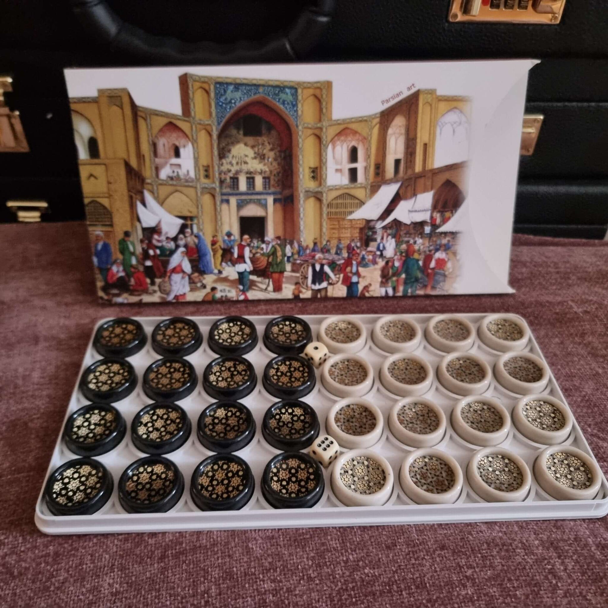 Khatam backgammon checkers set featuring intricately designed game pieces and a decorative box.