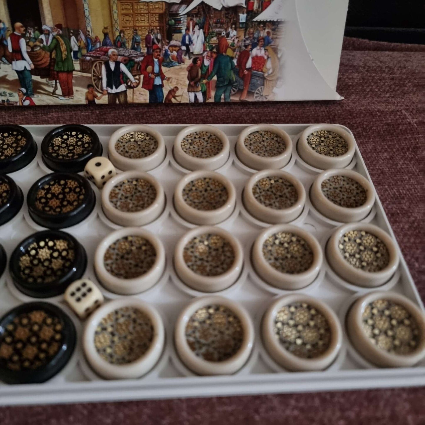 khatam backgammon checkers set displayed with ornate pieces and dice on a velvet background.