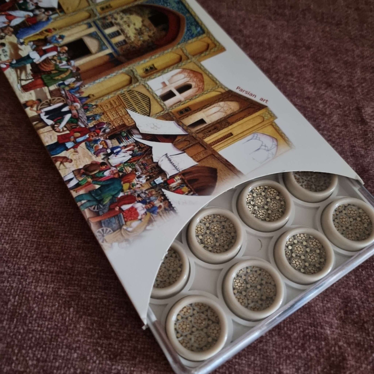 khatam backgammon checkers set packaging featuring persian art design with intricate patterns and decorative checkers.