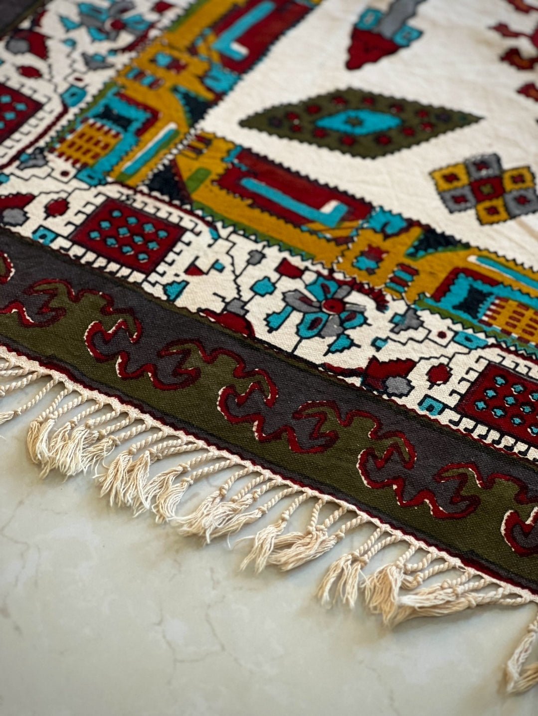 block printed cotton textile featuring vibrant geometric patterns in pink, terracotta, and deep forest green.