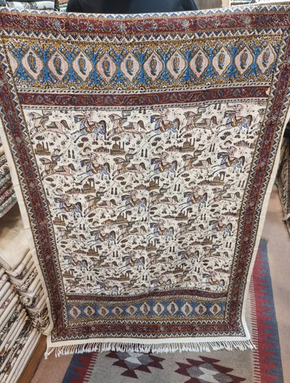 Block printed cotton textile featuring dynamic horse-rider scenes and paisley borders, size 100x150 cm.