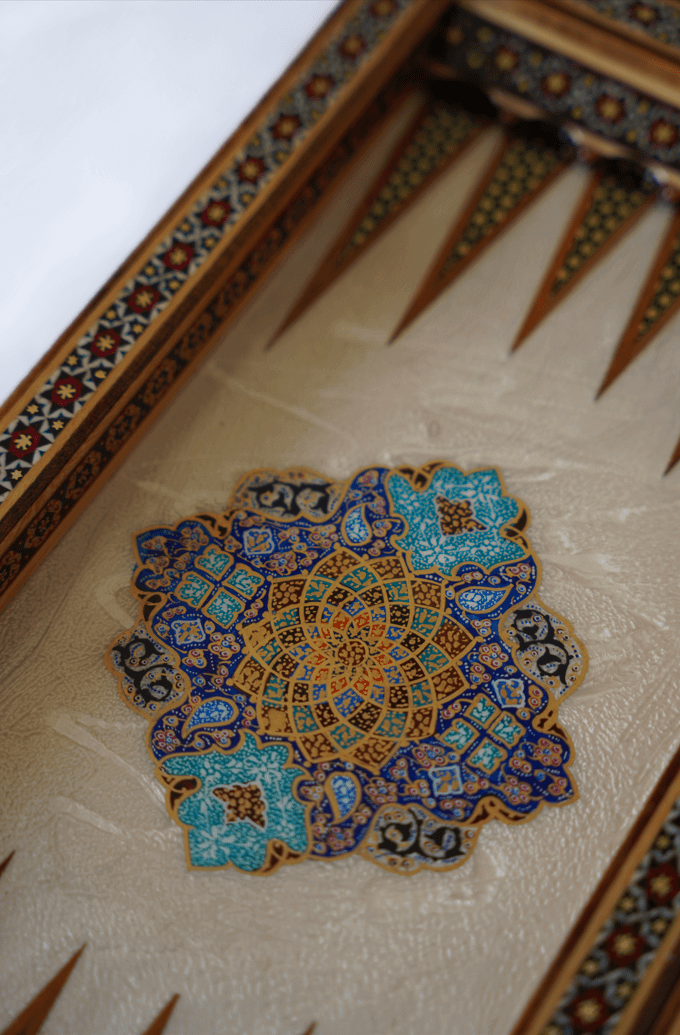 Close-up of intricate tazhib-inspired ornamentation on a compact chess and backgammon set by Pilardi.