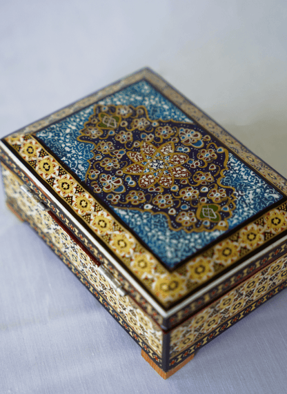 Handmade wooden jewelry box with hand-painted miniature lid and traditional detailing.