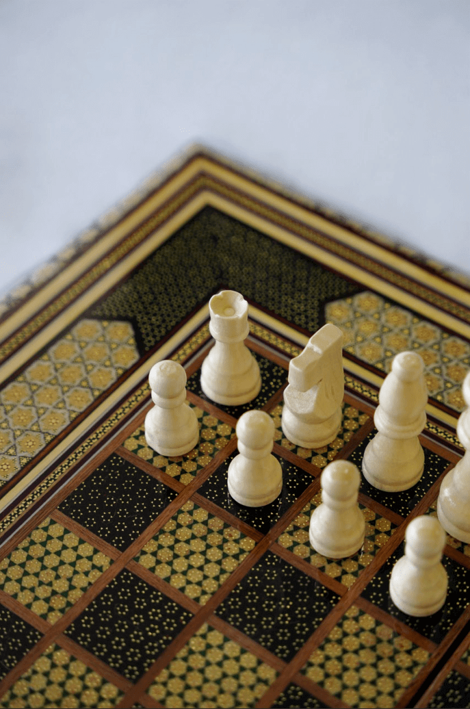 Khatam inlay chess and backgammon set with elegant wooden pieces on a beautifully crafted board.