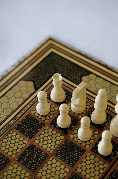 Khatam inlay chess and backgammon set with elegant wooden pieces on a beautifully crafted board.