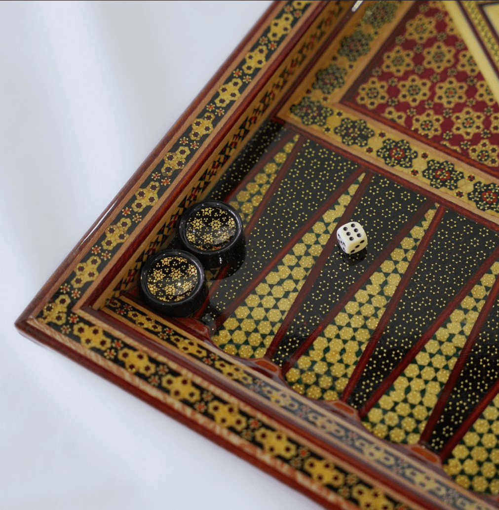 Khatam inlay chess and backgammon set featuring unique marquetry design and game pieces in play.