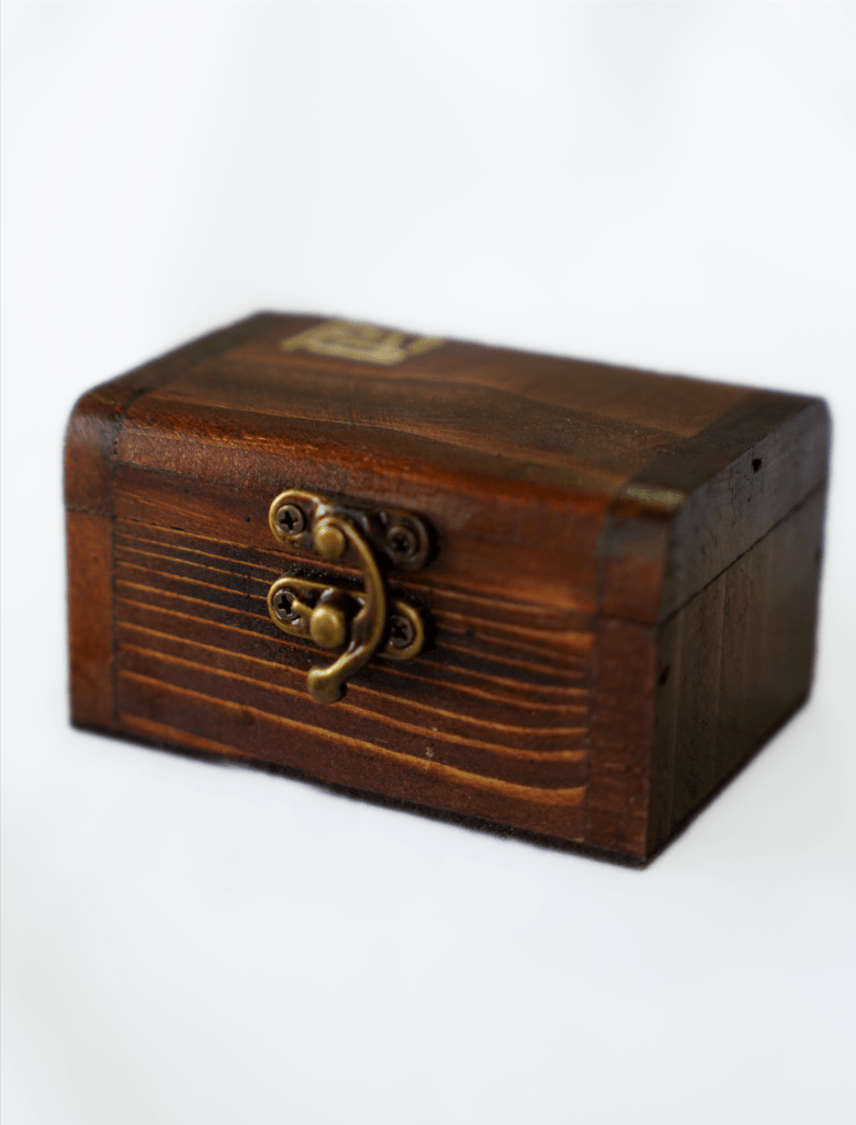 wooden treasure box with brass latch and vintage look on a white background.