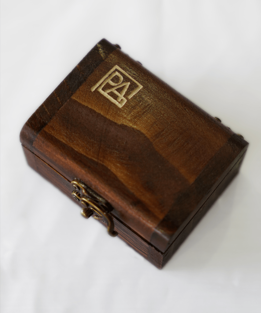 wooden jewelry box with engraved logo on lid, showcasing elegant craftsmanship and design.