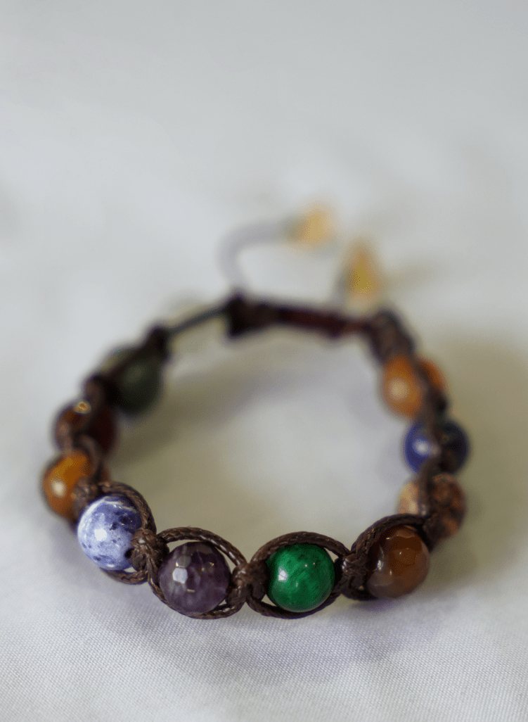 collector’s edition multi-stone macrame bracelet featuring natural gemstones, handcrafted for a unique accessory.