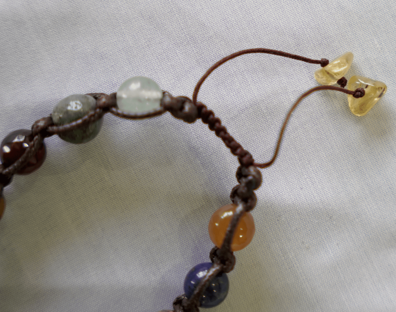 close-up of a collector’s edition multi-stone macramé bracelet featuring natural gemstones and handcrafted design.