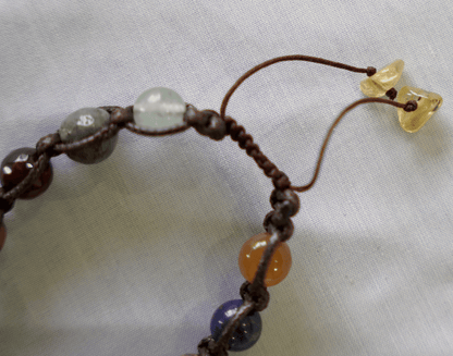 Close-up of a Collector’s Edition Multi-Stone Macramé Bracelet featuring natural gemstones and handcrafted design.