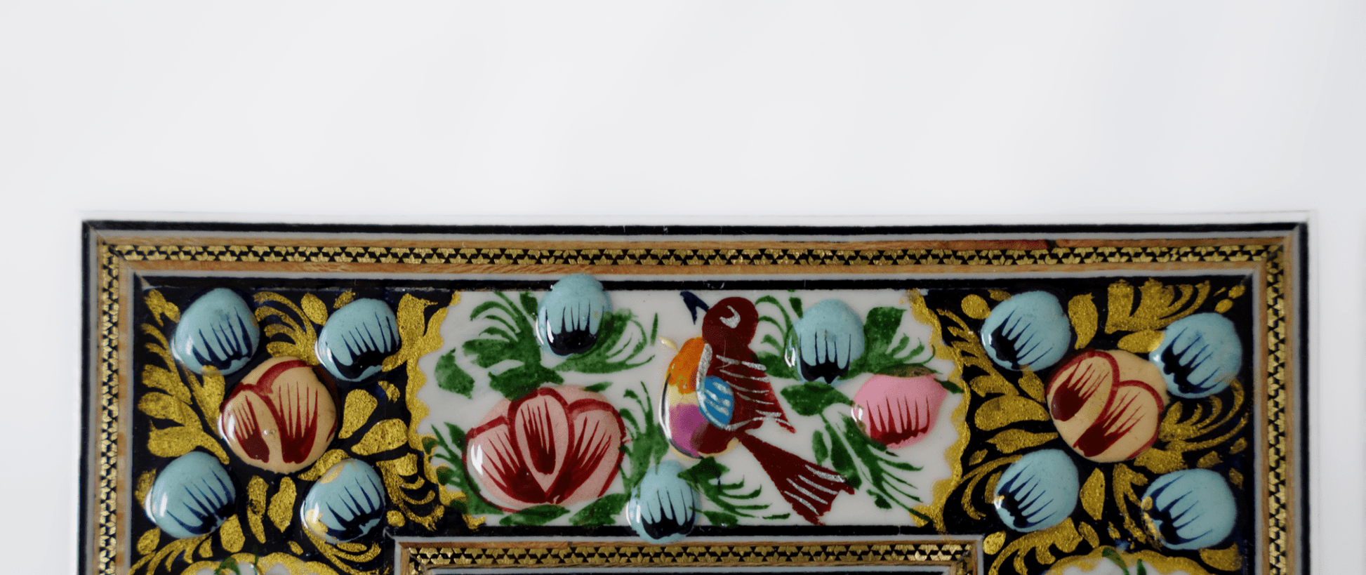 Hand-painted relief enamel mirror featuring vibrant florals and a colorful bird design.