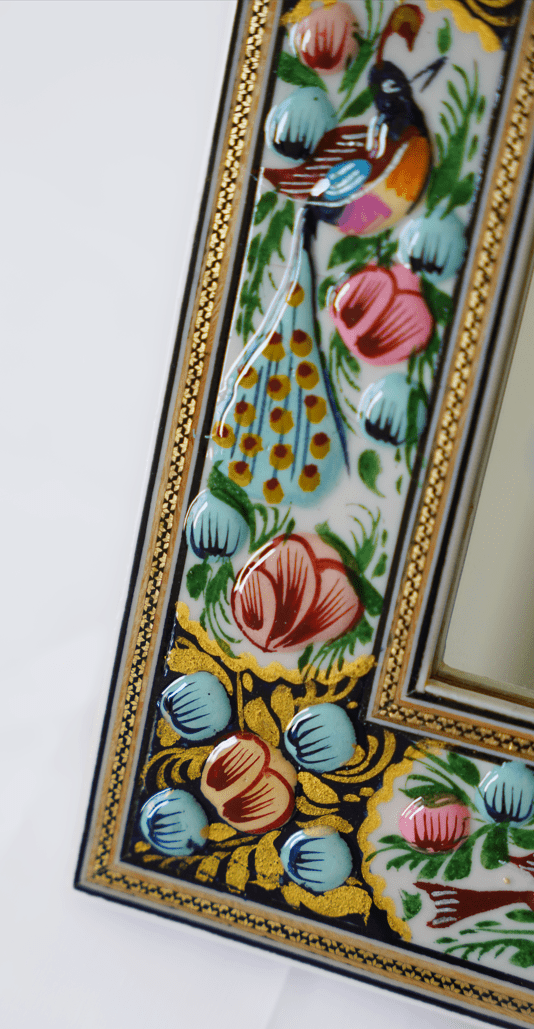 Hand-painted relief enamel mirror featuring vibrant florals and a decorative bird in a detailed raised enamel frame.