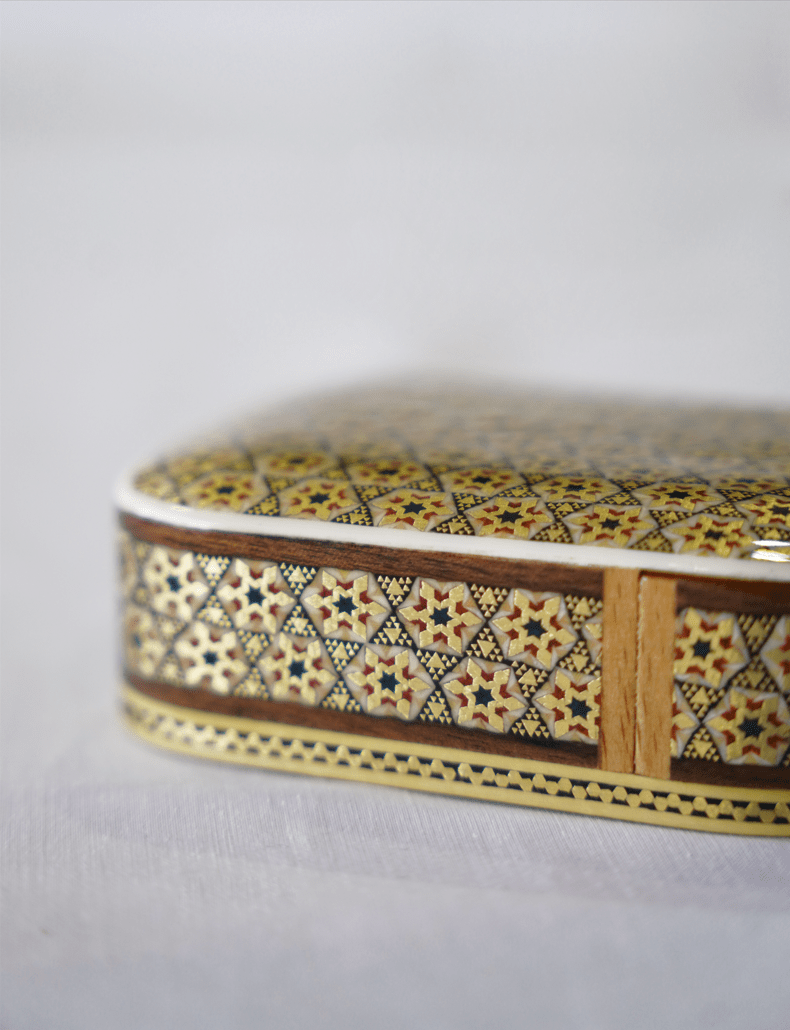 handmade wooden keepsake box featuring intricate marquetry design and glossy finish.