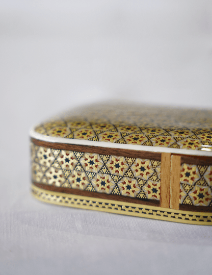 Handmade wooden keepsake box with intricate khatam marquetry design and a smooth, glossy finish.