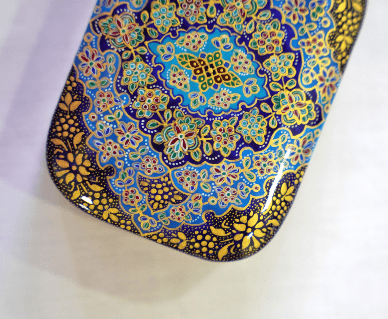 Handmade wooden keepsake box featuring a hand-painted Tazhib mandala in vibrant colors and intricate gold detailing.