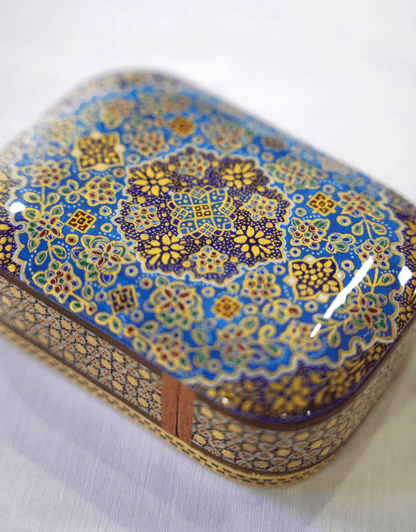 Handmade wooden keepsake box featuring intricate hand-painted miniature artwork in blue and gold.