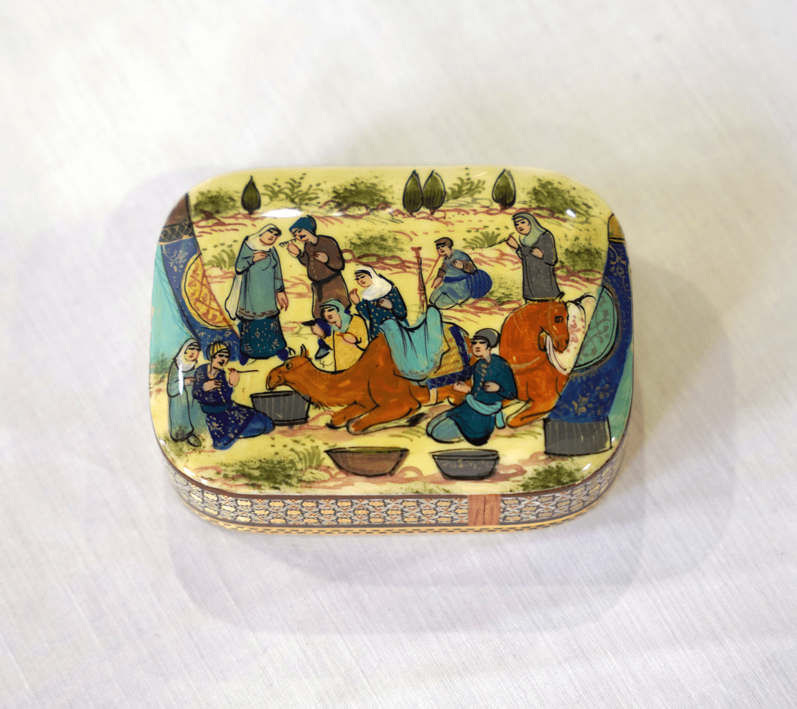 Handmade wooden keepsake box featuring traditional hand-painted artwork depicting figures and camels.