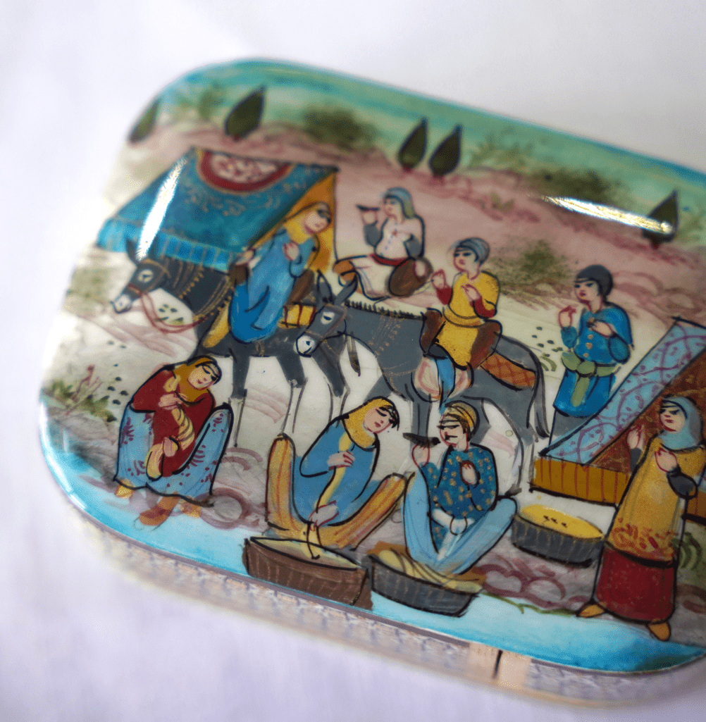 handmade wooden trinket box featuring hand-painted artwork depicting vibrant scenes with people and horses.