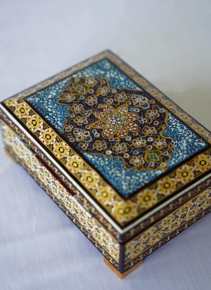 Handmade wooden jewelry box featuring a hand-painted miniature lid and intricate traditional detailing.
