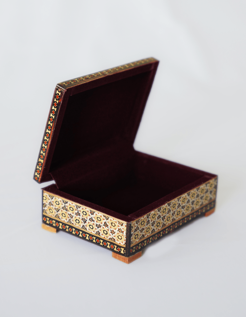 handmade wooden jewelry box with intricate designs and velvet lining, perfect for storing jewelry and keepsakes.
