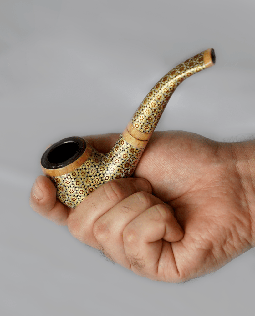 handcrafted khatam pipe held in hand, showcasing intricate marquetry and sculptural design for collectors.