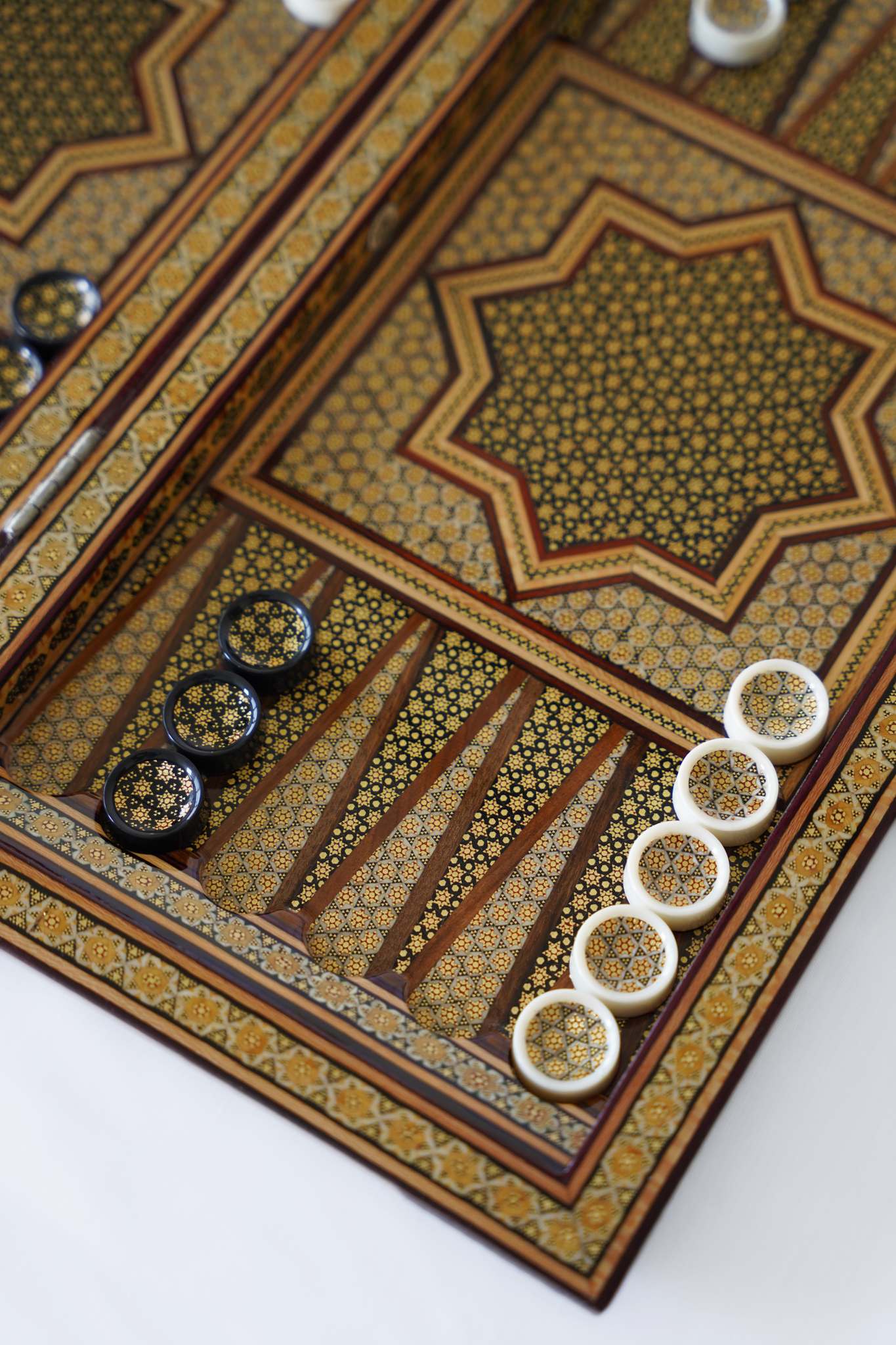 Hand-inlaid marquetry backgammon board with playing pieces in position