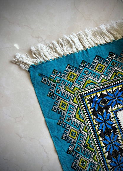 Block printed cotton textile - Firouzeh spread featuring bold geometric motifs in turquoise blue and intricate patterns.