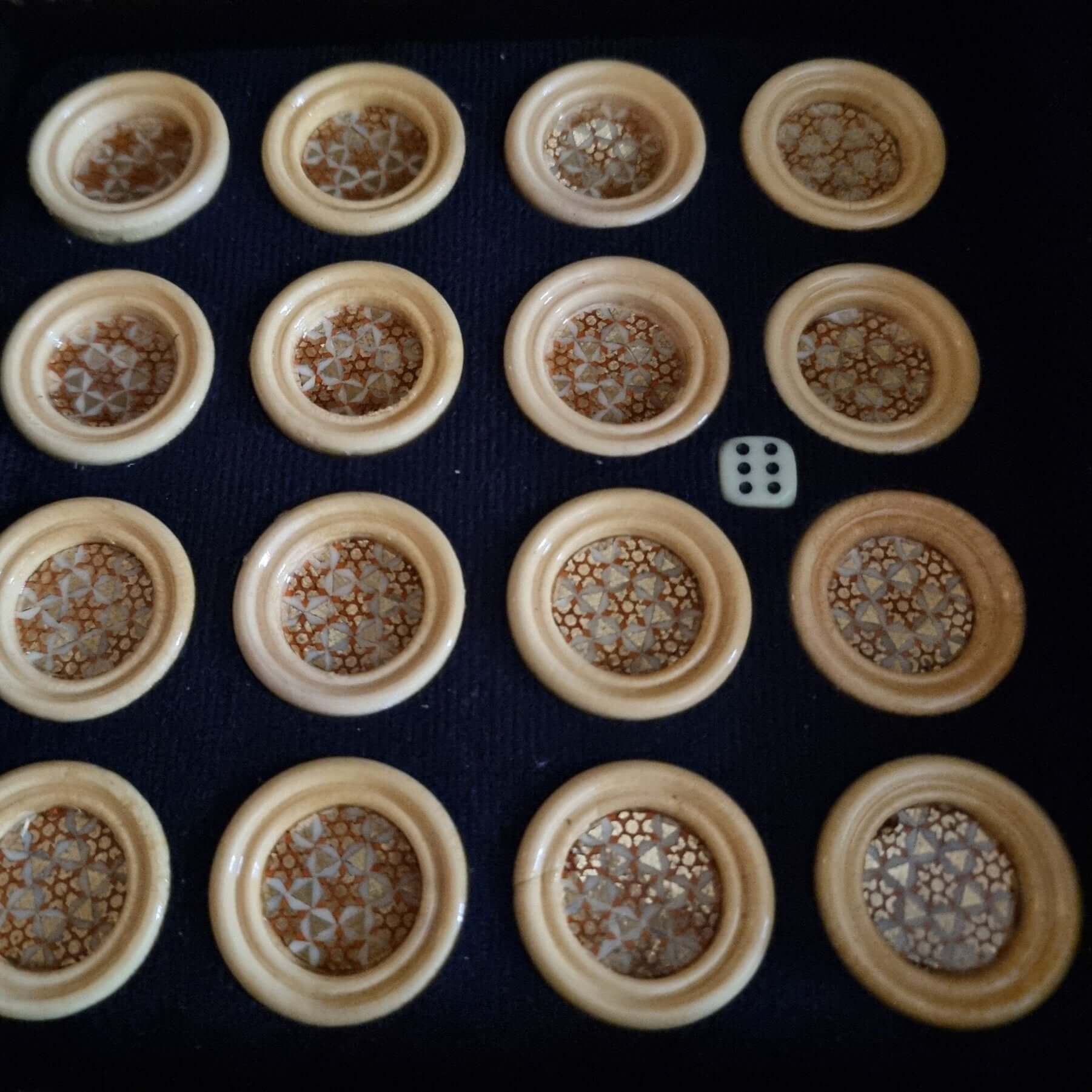 Khatam backgammon checkers set featuring handcrafted game pieces with intricate inlaid designs.