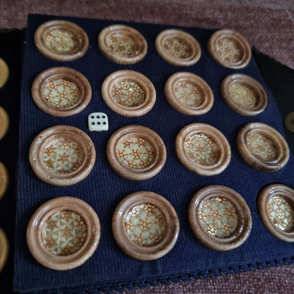 Close-up of premium Khatam backgammon checkers set showcasing handcrafted checkers on a felt board.